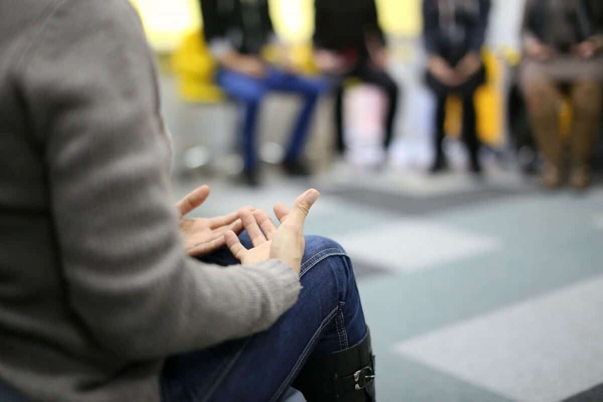 Woman's hands talking in group counseling